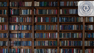 A large wooden bookshelf filled with academic books at Bryan University Resource Center, ideal for study and research.