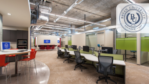 Interior view of Bryan University Resource Center featuring workstations, meeting areas, and branding elements.