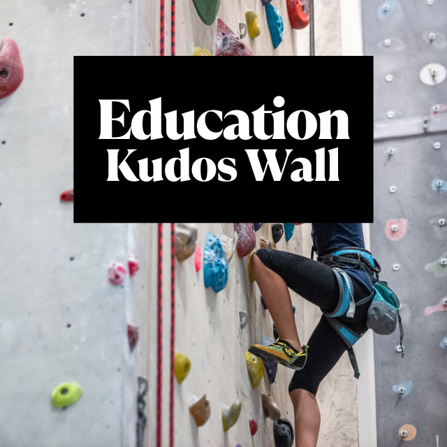 Image of a student climbing an indoor rock wall at the BU Resource Center, showcasing student achievements and motivation.